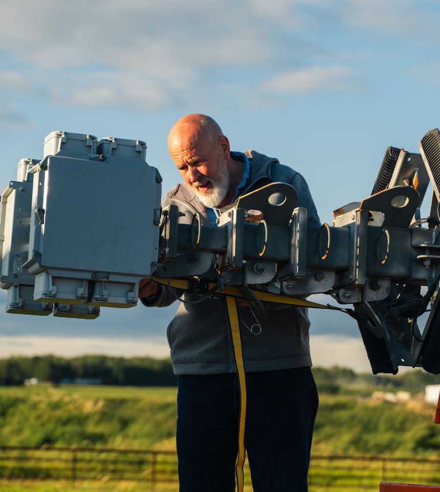 Technician setting up advanced surveillance equipment to support VSS mission of protecting Alberta job sites.